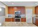 Bright kitchen with stainless steel appliances, granite counters, and classic-style wood cabinets at 740 Florida Blvd, Altamonte Springs, FL 32701