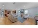 Bright living room boasts modern decor, hardwood floors, and views of the open-concept kitchen at 740 Florida Blvd, Altamonte Springs, FL 32701