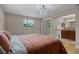 Comfortable bedroom featuring a modern light fixture, large window, closet and access to the bathroom at 740 Florida Blvd, Altamonte Springs, FL 32701