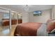 Relaxing bedroom boasts hardwood floors, ample lighting, a flat-screen TV, and an en-suite bathroom at 740 Florida Blvd, Altamonte Springs, FL 32701