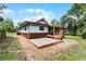 Charming home exterior featuring a stone patio, light-blue siding, and well-maintained landscaping at 740 Florida Blvd, Altamonte Springs, FL 32701