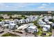 An aerial view showcases the neighborhood with modern townhomes, community pool, and beautiful landscaping at 7740 Sandy Ridge Dr # 114, Reunion, FL 34747