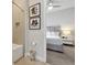 Cozy bathroom with a shower/tub and artwork, leading into a serene bedroom with a plush bed at 7740 Sandy Ridge Dr # 114, Reunion, FL 34747