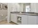 Bathroom with a double sink vanity, white cabinets, and modern decor at 7740 Sandy Ridge Dr # 114, Reunion, FL 34747