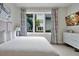 Bright bedroom with a large window, stylish curtains, and a comfortable bed with white linens at 7740 Sandy Ridge Dr # 114, Reunion, FL 34747