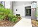 Close up of modern condo building 7740 entrance with well maintained landscaping at 7740 Sandy Ridge Dr # 114, Reunion, FL 34747