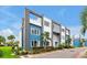 Modern building exterior with blue accents, manicured landscaping and an inviting street view at 7740 Sandy Ridge Dr # 114, Reunion, FL 34747