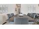 Dining room featuring a large wooden table with gray upholstered chairs and modern decor at 7740 Sandy Ridge Dr # 114, Reunion, FL 34747
