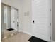 Welcoming condo entrance featuring a mirrored wall and a modern white door at 7740 Sandy Ridge Dr # 114, Reunion, FL 34747