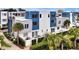 An eye-level view showcases the modern architecture and landscaping of the townhome exterior at 7740 Sandy Ridge Dr # 114, Reunion, FL 34747