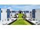 View showcases the modern townhome exteriors with manicured lawns in a thoughtfully designed community at 7740 Sandy Ridge Dr # 114, Reunion, FL 34747