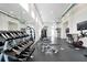 Spacious gym with modern equipment, weights, and mirrors for a complete workout at 7740 Sandy Ridge Dr # 114, Reunion, FL 34747