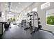 Well-equipped community gym with weights, cardio machines, and natural light at 7740 Sandy Ridge Dr # 114, Reunion, FL 34747