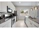 Bright kitchen with stainless steel appliances, modern countertops, and tile flooring at 7740 Sandy Ridge Dr # 114, Reunion, FL 34747