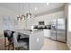 Modern kitchen with a large island, stainless steel appliances, and stylish pendant lights at 7740 Sandy Ridge Dr # 114, Reunion, FL 34747