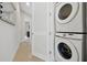 Modern laundry area with stacked washer and dryer, and ample storage space at 7740 Sandy Ridge Dr # 114, Reunion, FL 34747