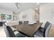 Open-concept living and dining area with modern furnishings and neutral color palette at 7740 Sandy Ridge Dr # 114, Reunion, FL 34747
