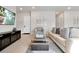 Bright living room with contemporary decor, tiled floors and a comfortable seating arrangement at 7740 Sandy Ridge Dr # 114, Reunion, FL 34747