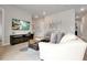 Cozy living room with modern furniture, neutral colors and a large television at 7740 Sandy Ridge Dr # 114, Reunion, FL 34747