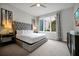 Bedroom featuring a tufted headboard, stylish decor, and a large window at 7740 Sandy Ridge Dr # 114, Reunion, FL 34747