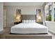Comfortable bedroom with a tufted headboard, bedside lamps, and neutral color scheme at 7740 Sandy Ridge Dr # 114, Reunion, FL 34747
