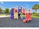 Community playground with climbing wall, slides, stairs, and monkey bars, offering outdoor fun at 7740 Sandy Ridge Dr # 114, Reunion, FL 34747