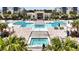 Resort-style pool area with lounge chairs, cabanas, and lush landscaping at 7740 Sandy Ridge Dr # 114, Reunion, FL 34747