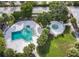 Aerial view of the community pool area with a pool and hot tub surrounded by palm trees and green space at 7900 S Orange Blossom Trl # 2108, Orlando, FL 32809
