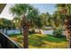 Lush backyard featuring palm trees, white picket fences and partial pool view at 7900 S Orange Blossom Trl # 2108, Orlando, FL 32809