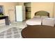 Bright bedroom with a comfortable bed, tile floors, and a kitchenette at 7900 S Orange Blossom Trl # 2108, Orlando, FL 32809