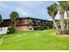 Motel exterior with lush green lawn and tropical landscaping at 7900 S Orange Blossom Trl # 2108, Orlando, FL 32809