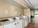 Community laundry room featuring multiple washing machines and dryers at 7900 S Orange Blossom Trl # 2108, Orlando, FL 32809