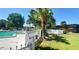 Community pool area with swimming pool, chairs, lounge and mature tropical landscaping at 7900 S Orange Blossom Trl # 2108, Orlando, FL 32809