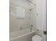 Bright bathroom featuring a tiled shower-over-tub and window at 809 Kazaros Cir, Ocoee, FL 34761