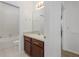 Bathroom featuring a vanity with cherry cabinets, a mirror, and access to a toilet and shower at 809 Kazaros Cir, Ocoee, FL 34761