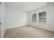 Bright bedroom with neutral carpet and two large windows at 809 Kazaros Cir, Ocoee, FL 34761