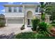 Charming two-story home with stone accents, manicured landscaping and a brick driveway at 809 Kazaros Cir, Ocoee, FL 34761
