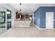 Bright kitchen with stainless appliances, breakfast bar, and access to the outdoor patio at 809 Kazaros Cir, Ocoee, FL 34761