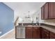 Stylish kitchen with stainless appliances and granite countertops overlooking the living area at 809 Kazaros Cir, Ocoee, FL 34761