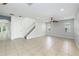 Spacious living room with staircase, tile floors, and neutral paint at 809 Kazaros Cir, Ocoee, FL 34761