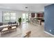Open living space with tiled flooring, kitchen bar seating, and backyard views at 809 Kazaros Cir, Ocoee, FL 34761