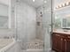Modern shower with glass enclosure, rain shower head and stone tile floor at 809 Kazaros Cir, Ocoee, FL 34761