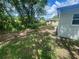 Spacious backyard with lush greenery, mature trees, and a chain link fence at 8320 Dominguin St, Orlando, FL 32817