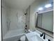Modern bathroom with granite vanity, tub with tile surround, and updated fixtures at 8320 Dominguin St, Orlando, FL 32817