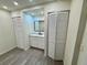 Bright bathroom featuring a vanity with a modern faucet and neutral walls at 8320 Dominguin St, Orlando, FL 32817
