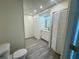 Bright bathroom with plank floors, ample storage, vanity and neutral paint at 8320 Dominguin St, Orlando, FL 32817
