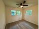 Well-lit bedroom with wood-look floors and a ceiling fan at 8320 Dominguin St, Orlando, FL 32817