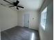 Bright bedroom with a ceiling fan, natural light, and wood-look floors at 8320 Dominguin St, Orlando, FL 32817