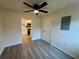 A well-lit dining room features sleek gray wood floors and a modern ceiling fan and an open view to a kitchen at 8320 Dominguin St, Orlando, FL 32817