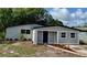 Charming single-story home featuring a freshly painted exterior and a cozy, inviting front porch at 8320 Dominguin St, Orlando, FL 32817